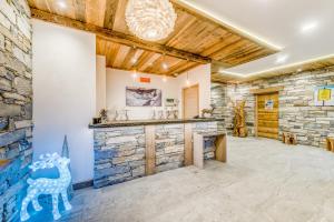 a large room with a stone wall and a fireplace at Residence Cap Neige in Tignes