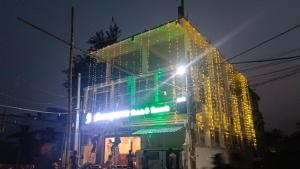 a building with christmas lights on it at night at Arnnapurna Hotel & Resort in Jājpur
