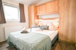 a small bedroom with a bed and a window at Ferienhaus Ostseechalet Seestern Gelting in Gelting