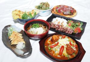 a group of plates of food on a table at HOTEL FINE - INTO THE PREMlUM - in Okazaki