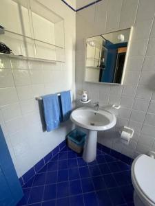 a bathroom with a sink and a toilet and a mirror at Residenza Santa Maria in Capri