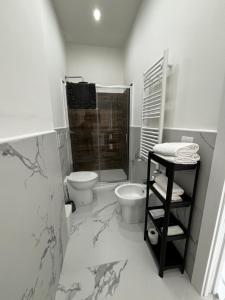 a white bathroom with a toilet and a shower at Villa Life in San Donato Milanese