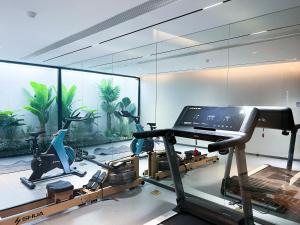 a room with a gym with bikes and a laptop at Yizhi Hotel - Guangzhou East Railway Station Tianhe Sports Center in Guangzhou