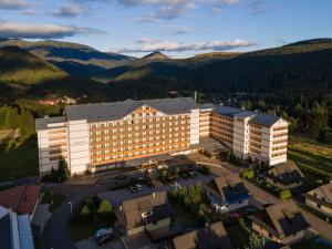 an aerial view of a hotel with mountains in the background at Apartmanica Residence 511 in Donovaly