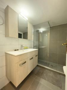 a bathroom with a sink and a shower at Gtrip Nea Smyrni Apartment - 3421 in Athens