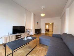 a living room with a couch and a tv at Gtrip Nea Smyrni Apartment - 3421 in Athens