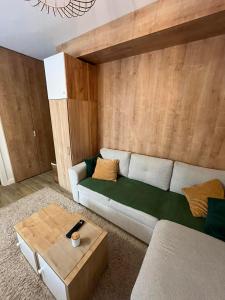 a living room with a couch and a coffee table at Apartman Lenka Villa Mont Jahorina in Jahorina