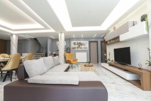 a living room with a couch and a tv at Ulivi Verdi Villa in Kontokali