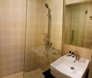 a bathroom with a shower and a sink at 2-Bedroom Condo with City Skyline View in Vientiane