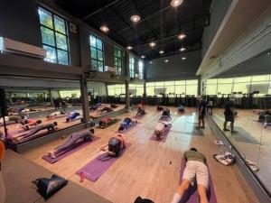 a group of people doing yoga in a gym at 2-Bedroom Condo with City Skyline View in Vientiane
