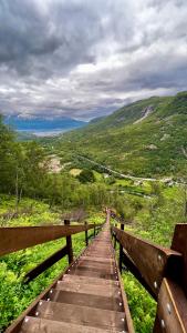a wooden path leading down a hill with a view at Artic Dream in Gratangen