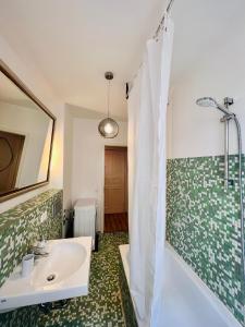 a bathroom with a sink and a tub and a shower at Central City Cosy Lux in Berlin