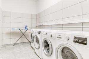 a white laundry room with a washer and dryer at Residence Cap Neige in Tignes