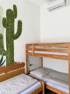 a room with two bunk beds and a cactus on the wall at Esztergom Central in Esztergom