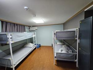 a room with two bunk beds in it at Y's house in Seoul