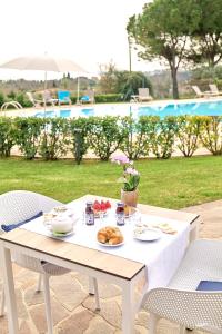 a table with a plate of food on it at Moniga Resort in Moniga