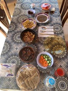 a table with various dishes of food on it at Tasneem Palace in Luxor