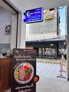 a sign in front of a building with a bowl of food at Luna hotel in Ban Ko