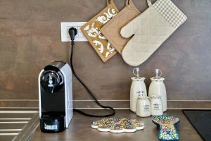 a kitchen counter with a coffee maker and milk containers at Moniga Resort in Moniga