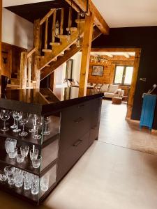 a kitchen with a counter with wine glasses at Marzeniówka in Lutowiska