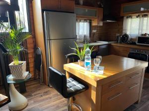 a kitchen with a stainless steel refrigerator and a wooden island at Bustan HaZait in Nahariyya