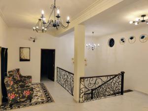 un salon avec un escalier et un lustre dans l'établissement Villa Forever Coorg, à Madikeri