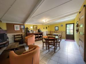 a living room with a table and chairs at Relais du Volcan in La Plaine des Cafres