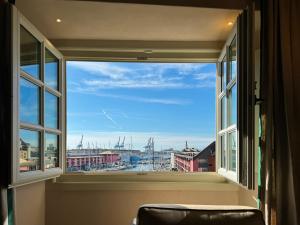 a large window with a view of a harbor at Hotel Palazzo Durazzo Suites in Genoa
