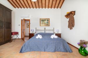 モンテスペルトリにあるAgriturismo La Capannaのベッドルーム1室(青と白の毛布付きのベッド1台付)