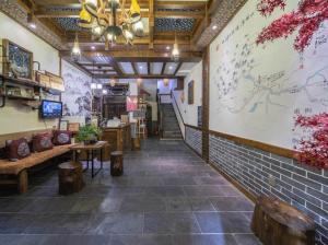 a restaurant with tables and chairs and a ceiling at Mountains Beyond Mountains Inn in Zhangjiajie
