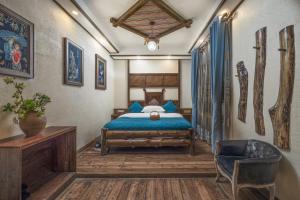 1 dormitorio con 1 cama y 1 silla en Mountains Beyond Mountains Inn en Zhangjiajie