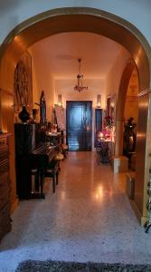 an archway in a room with a piano and a pianesthetic at Saracini's Homestay - 156, Emerald in Attard