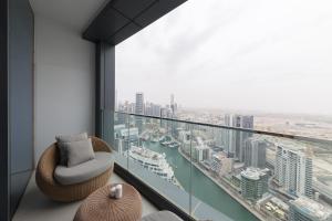 a room with a balcony with a view of a harbor at Fabulous 1BR apartment in Address Beach Resort in Dubai