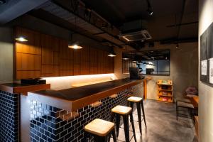 a kitchen with a bar with stools in it at hotel Bell・Kyoto in Kyoto