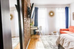 a bedroom with a red couch and a brick wall at 26-3A STUDIO Gramercy W D Outdoor Courtyard in New York