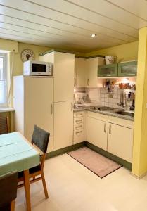 a small kitchen with a table and a refrigerator at Ferienwohnung Singer in Bad Reichenhall