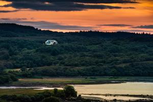 a house on top of a hill with a river at Killoran House in Dervaig