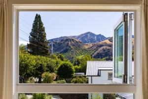 a window with a view of mountains at The Apartment at Arrowtown in Arrowtown