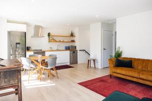 a living room with a couch and a table at The Apartment at Arrowtown in Arrowtown
