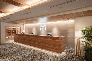 a lobby with a reception desk in a building at Sauna & Capsule AMZA (mens only) in Osaka