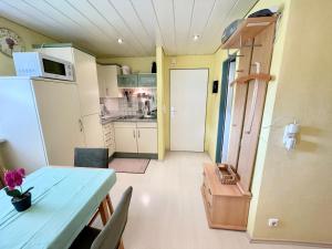 a small kitchen with a table and a refrigerator at Ferienwohnung Singer in Bad Reichenhall