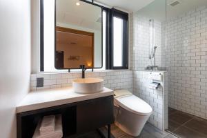 a white bathroom with a sink and a toilet at hotel Bell・Kyoto in Kyoto