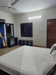 a large mattress in a room with a ceiling at Hotel Capital one in Karachi