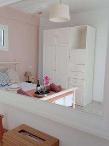 a white bedroom with a bed and a table at Villa Santa Marina in Spetses