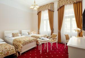 a hotel room with two beds and a table at Alqush Downtown Hotel in Prague