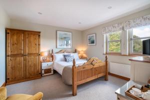 a bedroom with a bed and a large window at Killoran House in Dervaig