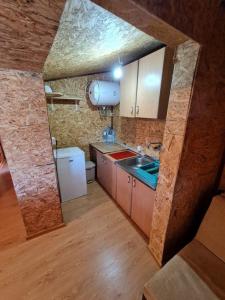 a kitchen with a sink and a refrigerator at Ada Bojana - Kucica Djakonovic in Ulcinj