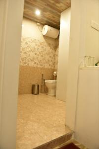a bathroom with a toilet in a room at Hotel Pinnacle in Dehradun