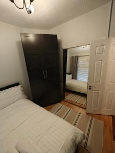 a bedroom with a bed and a closet and a mirror at Delightful 3 Bed Dublin City House in Dublin