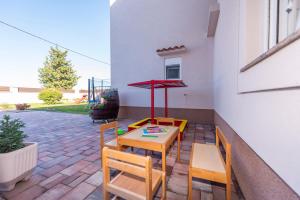a patio with a table and chairs and a table at Villa Toni - Adriatic Luxury Villas in Zadar